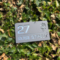 Rose floral house sign installed on rendered wall – grey acrylic
