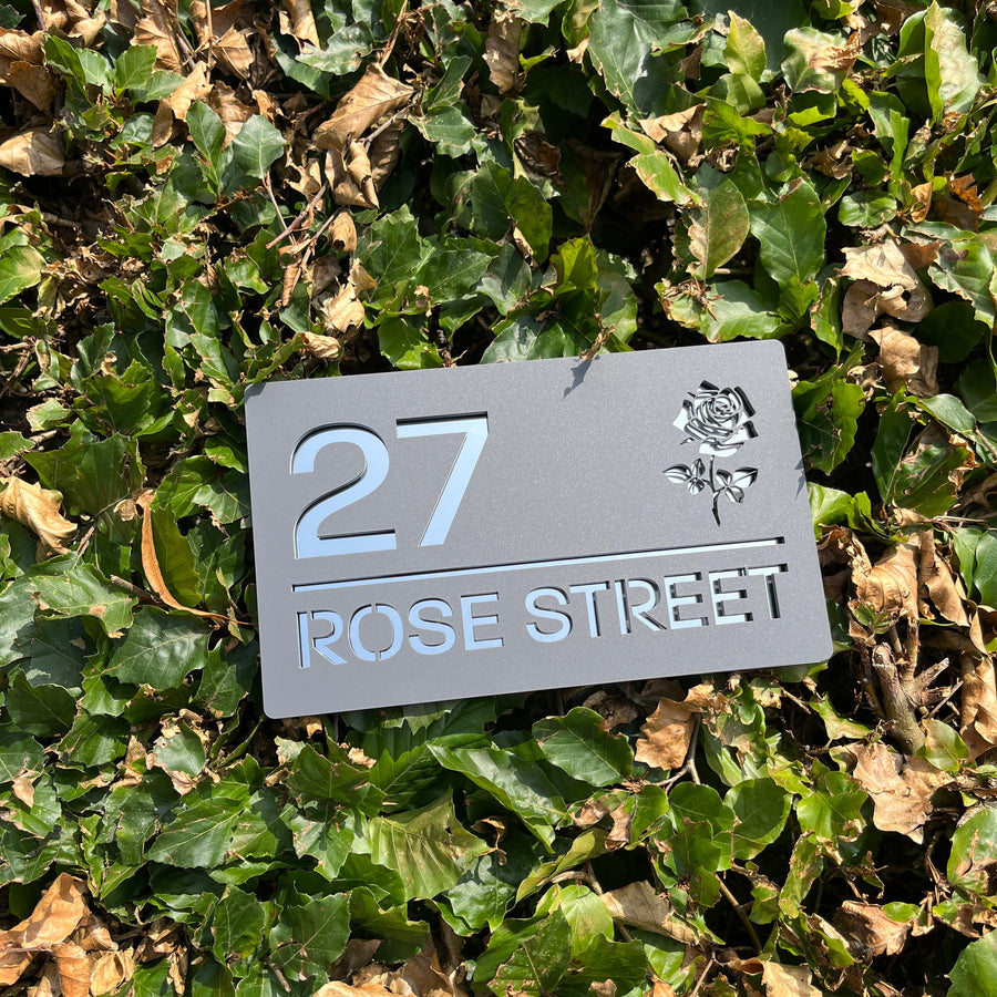 Rose floral house sign installed on rendered wall – grey acrylic