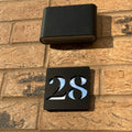Matt black door number sign close-up – personalised stick on acrylic