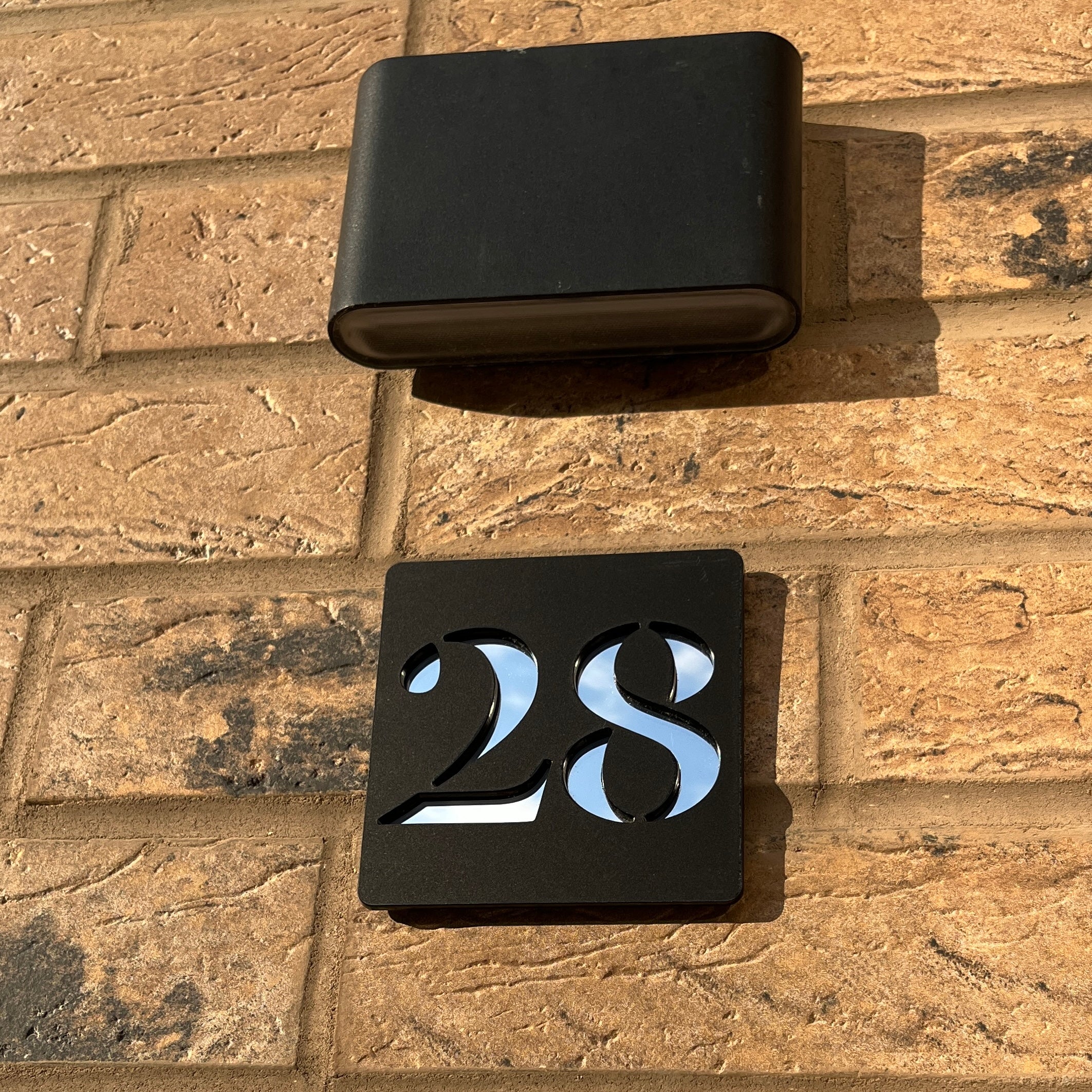 Matt black door number sign close-up – personalised stick on acrylic