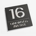 Matt black metallic house sign installed on rendered wall – silver mirror backing