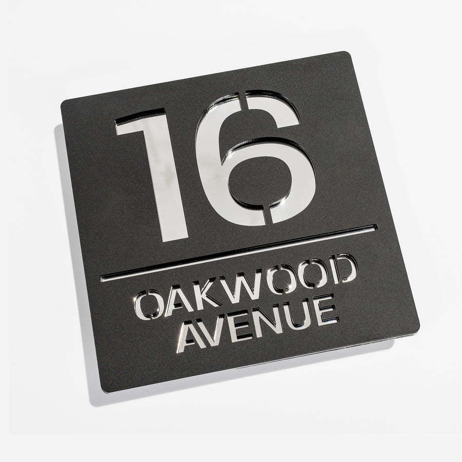 Matt black metallic house sign installed on rendered wall – silver mirror backing