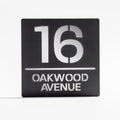 Matt black metallic house sign with silver mirror backing – modern acrylic design installed on wall