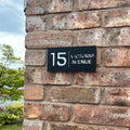 Matt black stick on house sign with silver mirror backing – close-up product shot