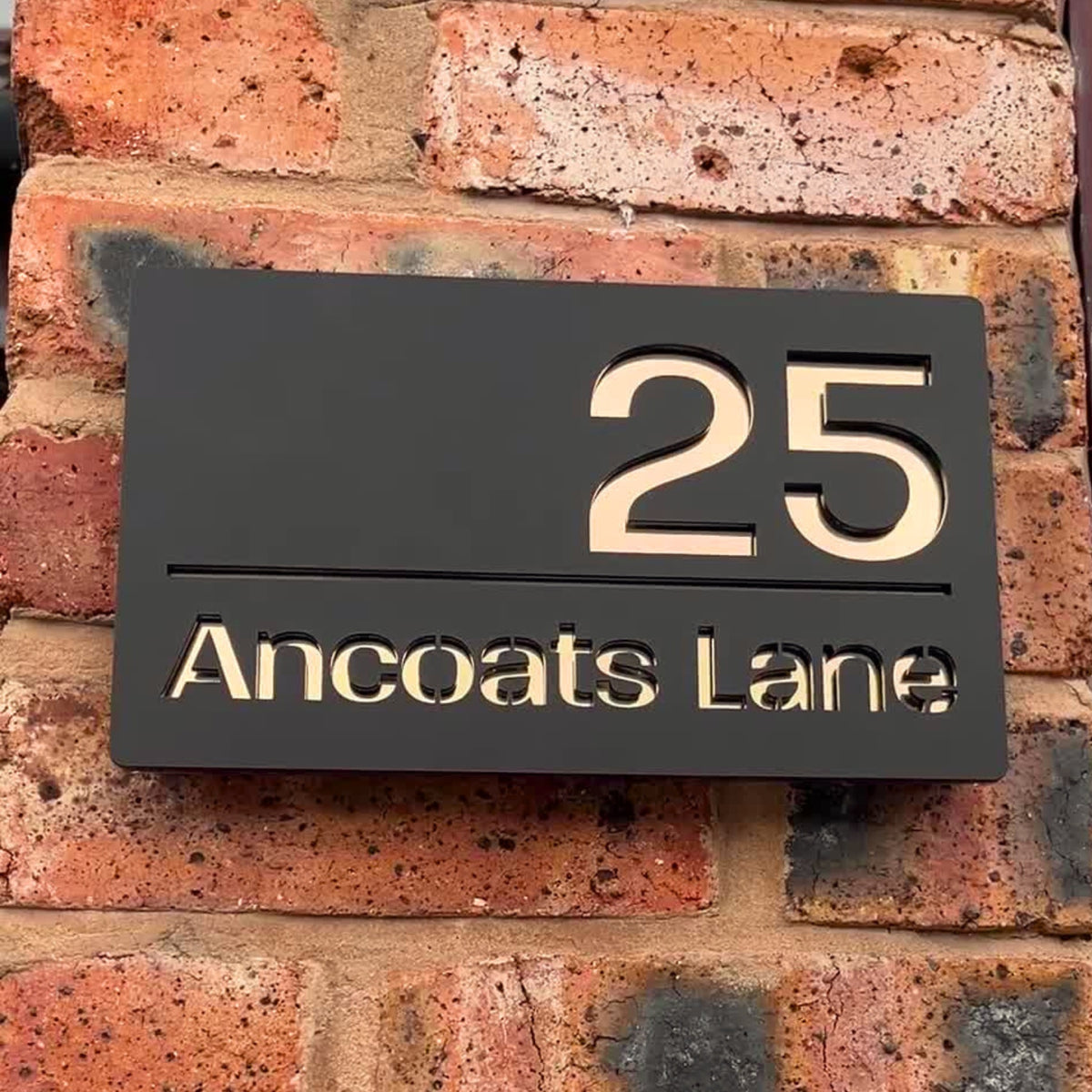 Modern house sign installed on a contemporary home exterior