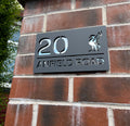 Personalised Liver Bird house sign installed on rendered wall