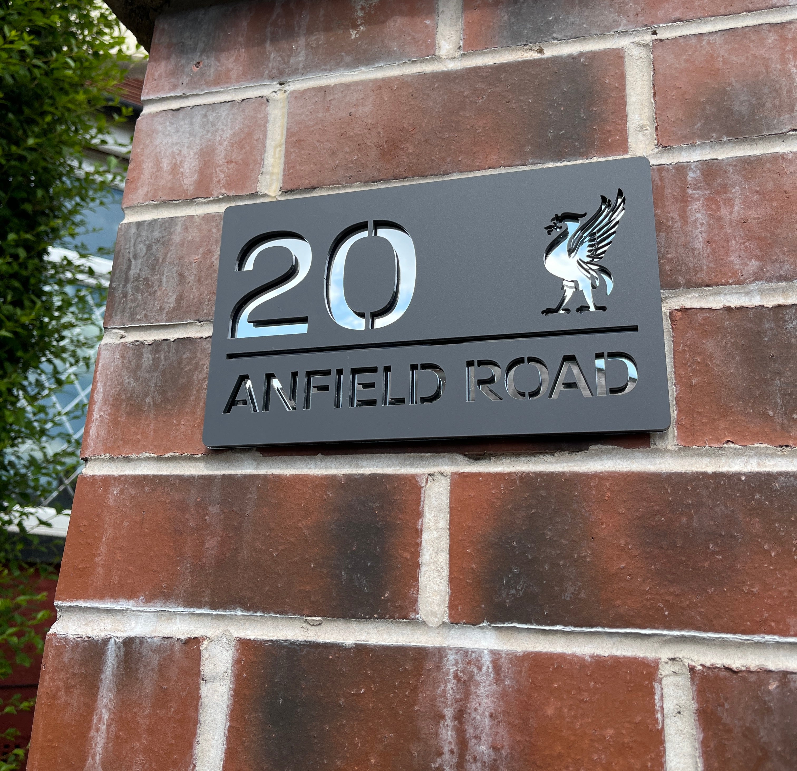 Personalised Liver Bird house sign installed on rendered wall