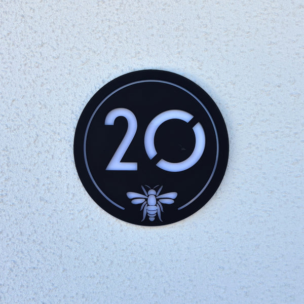 Manchester Bee House Sign in matt black with house number 20 and bee emblem, front view