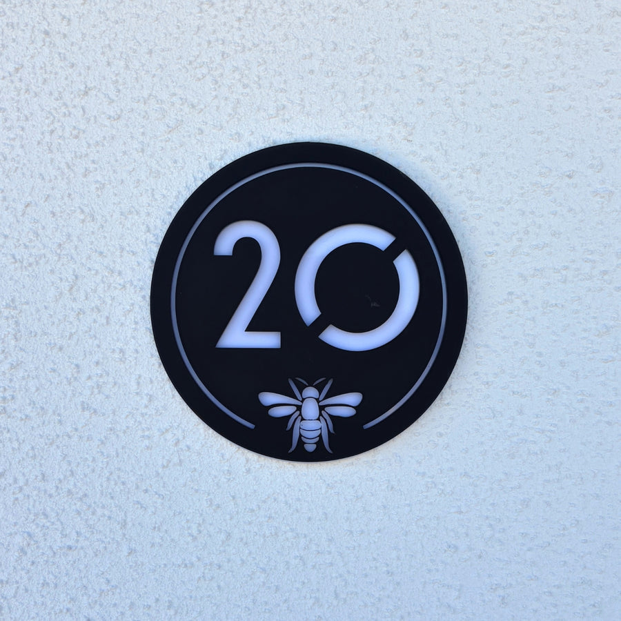 Manchester Bee House Sign in matt black with house number 20 and bee emblem, front view