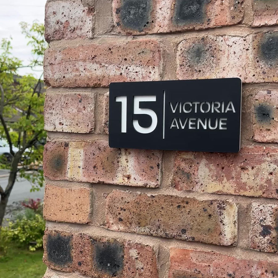 Matt black rectangle stick on house sign installed on wall – modern acrylic design