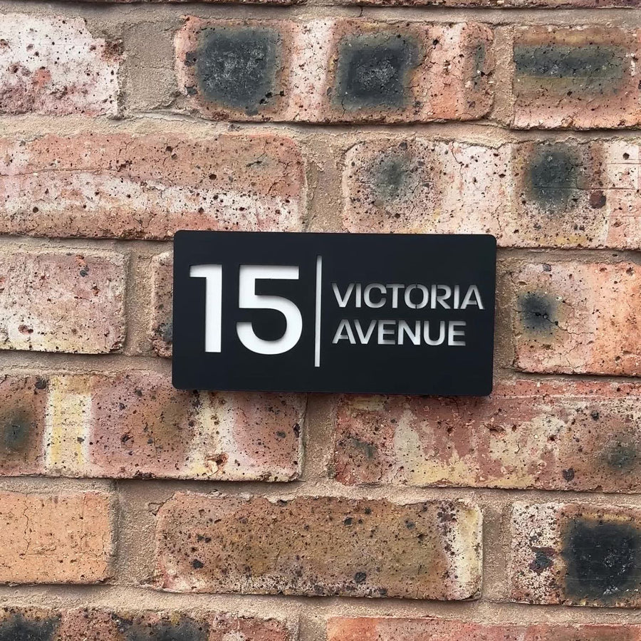 Stick on matt black house sign installed on rendered wall – no tools required