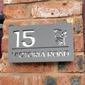 Modern floral house sign installed on wall – personalised matt grey acrylic