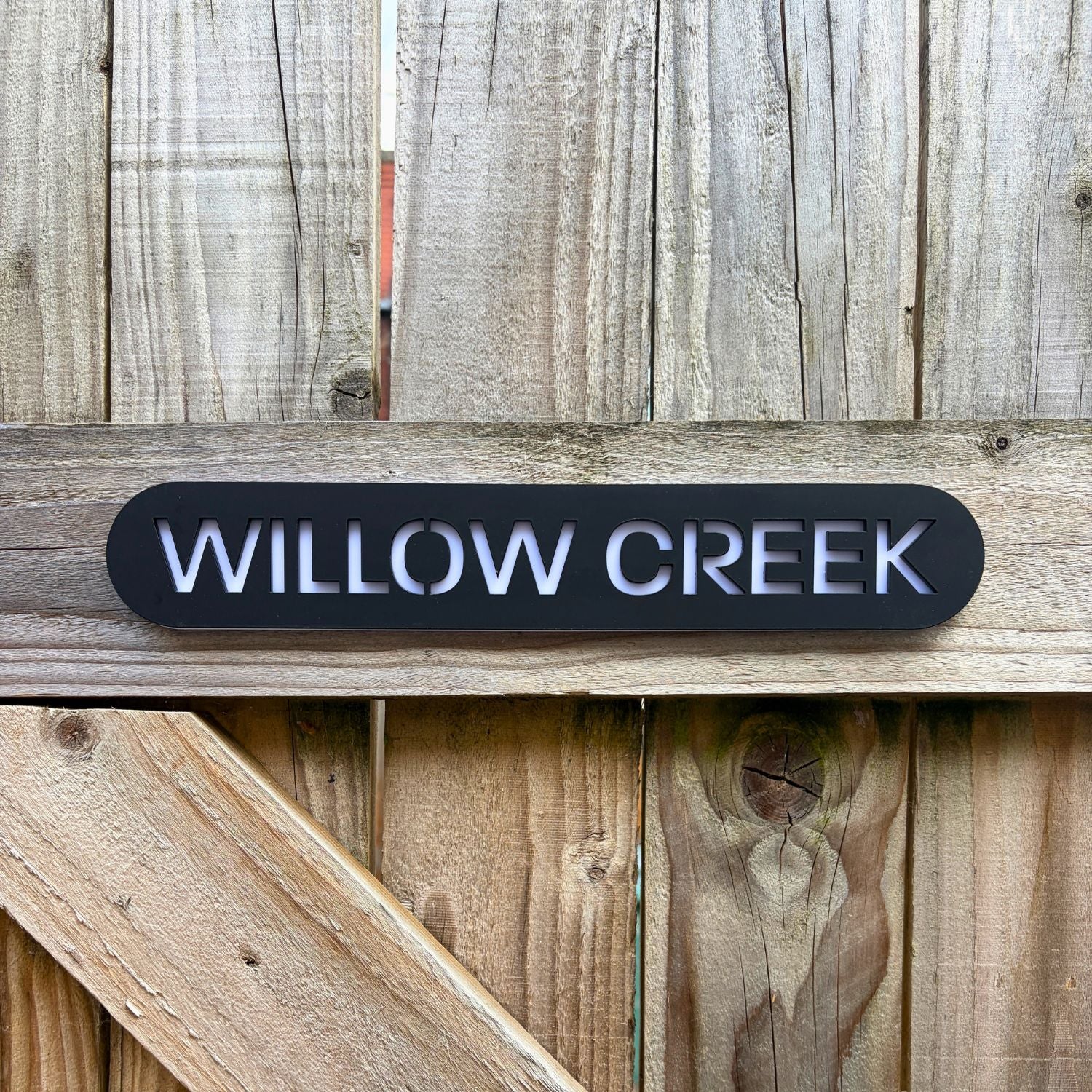 Modern house name sign installed on wood cladding – personalised stick on acrylic