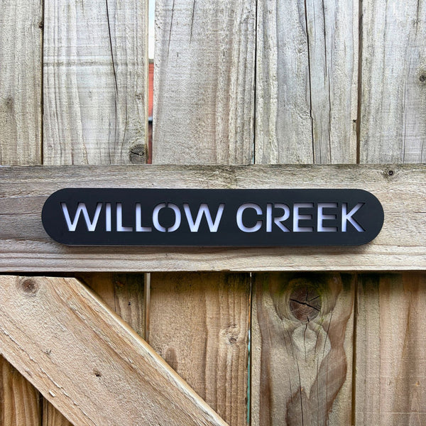 Modern house name sign installed on wood cladding – personalised stick on acrylic