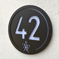 Turtle House Sign in walnut brown mounted on a rendered exterior wall, shown at an angle