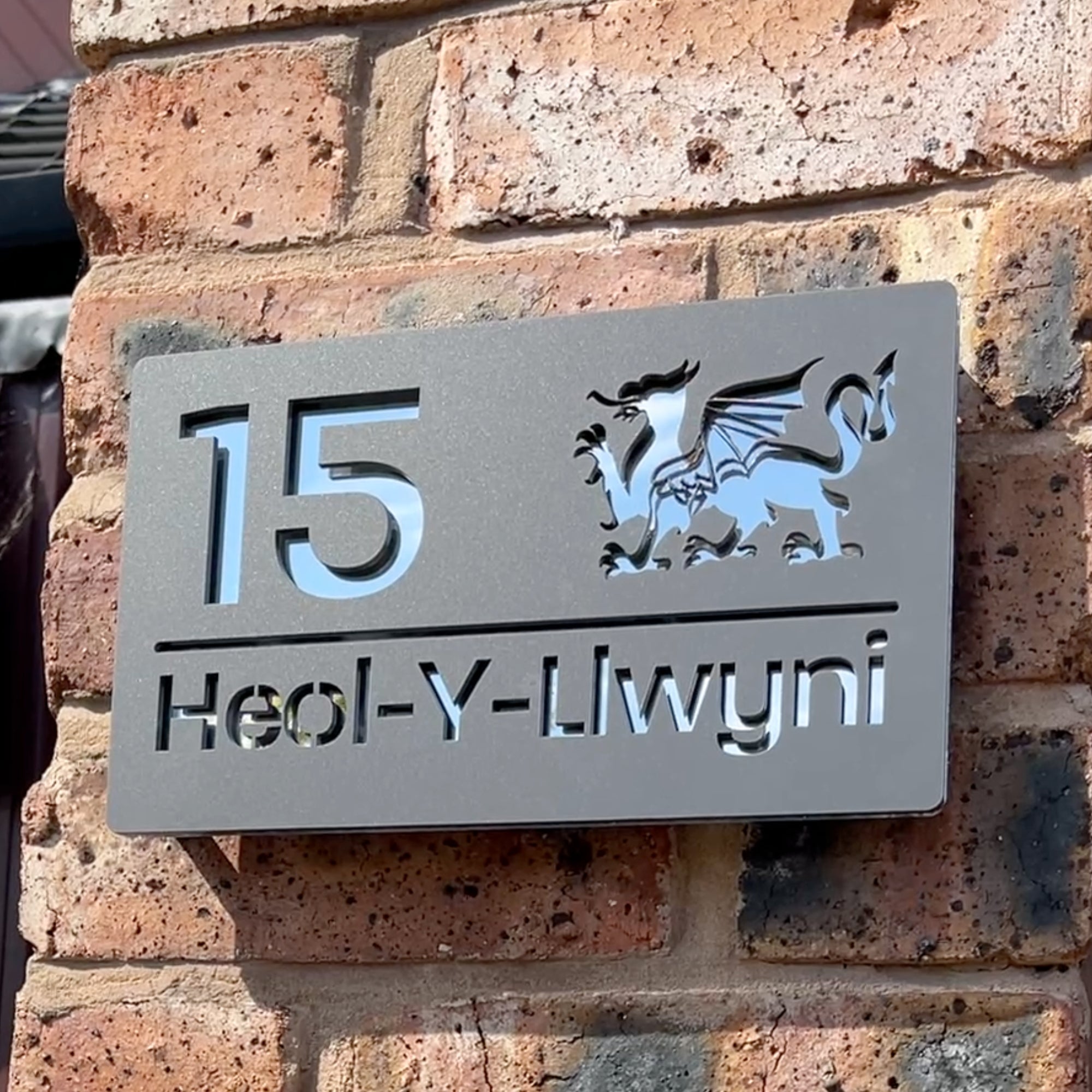 Welsh Dragon house sign installed on wall – personalised matt grey acrylic