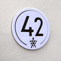 Close-up detail of the Turtle House Sign in white showing the laser-cut turtle motif